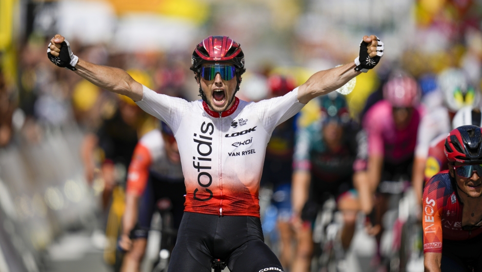 France's Victor Lafay crosses the finish line to win the second stage of the Tour de France cycling race over 209 kilometers (130 miles) with start in Vitoria Gasteiz and finish in San Sebastian, Spain, Sunday, July 2, 2023. (AP Photo/Daniel Cole)
