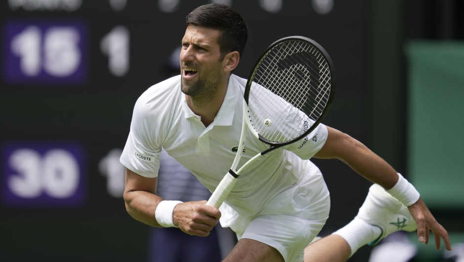 Serbia's Novak Djokovic serves to Argentina's Pedro Cachin during their first round men's singles match on day one of the Wimbledon tennis championships in London, Monday, July 3, 2023. (AP Photo/Kin Cheung)