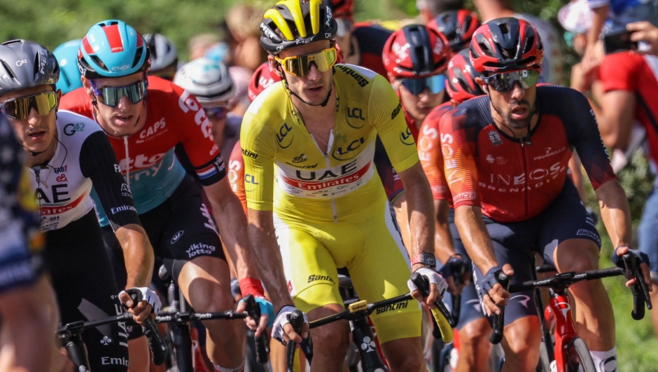UAE Team Emirates' British rider Adam Yates wearing the overall leader's yellow jersey cycles with the pack of riders in Hendaye during the 3rd stage of the 110th edition of the Tour de France cycling race, 193,5 km between Amorebieta-Etxano in Northern Spain and Bayonne in southwestern France, on July 3, 2023. (Photo by Thomas SAMSON / AFP)