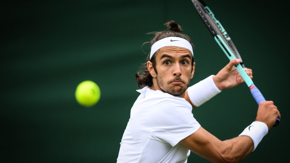 Italy's Lorenzo Musetti eyes the ball as he returns it to Peru's Juan Pablo Varillas during their men's singles tennis match on the first day of the 2023 Wimbledon Championships at The All England Tennis Club in Wimbledon, southwest London, on July 3, 2023. (Photo by Daniel LEAL / AFP) / RESTRICTED TO EDITORIAL USE