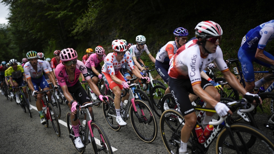 Neilson Powless of the U.S., center, lost his best climber's dotted jersey to Austria's Felix Gall during the fifth stage of the Tour de France cycling race over 163 kilometers (101 miles) with start in Pau and finish in Laruns, France, Wednesday, July 5, 2023. (AP Photo/Daniel Cole)