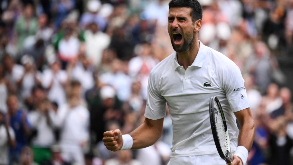 Serbia's Novak Djokovic celebrates winning against Russia's Andrey Rublev during their men's singles quarter-finals tennis match on the ninth day of the 2023 Wimbledon Championships at The All England Tennis Club in Wimbledon, southwest London, on July 11, 2023. (Photo by Daniel LEAL / AFP) / RESTRICTED TO EDITORIAL USE
