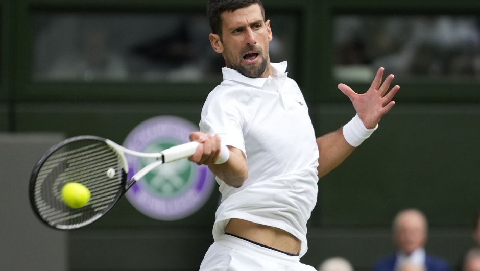 Serbia's Novak Djokovic returns to Russia's Andrey Rublev in a men's singles match on day nine of the Wimbledon tennis championships in London, Tuesday, July 11, 2023. (AP Photo/Kirsty Wigglesworth)