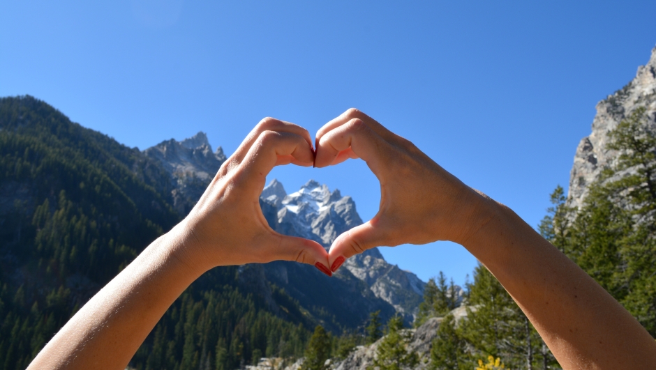 Heart shaped hands encompassing the Grand Teton in Grand Teton National Park in Wyoming.