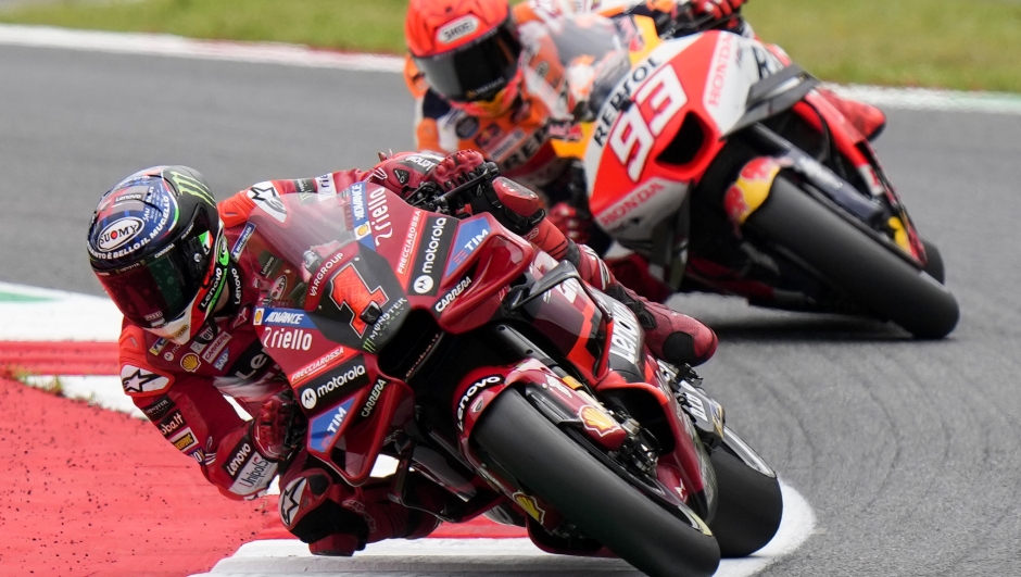 Italy's Francesco Bagnaia rides his Ducati followed by Spain's Marc Marquez during the qualifying session for the MotoGP Italian Grand Prix, at the Mugello circuit in Scarperia, Italy, Saturday, June 10, 2023. (AP Photo/Luca Bruno)