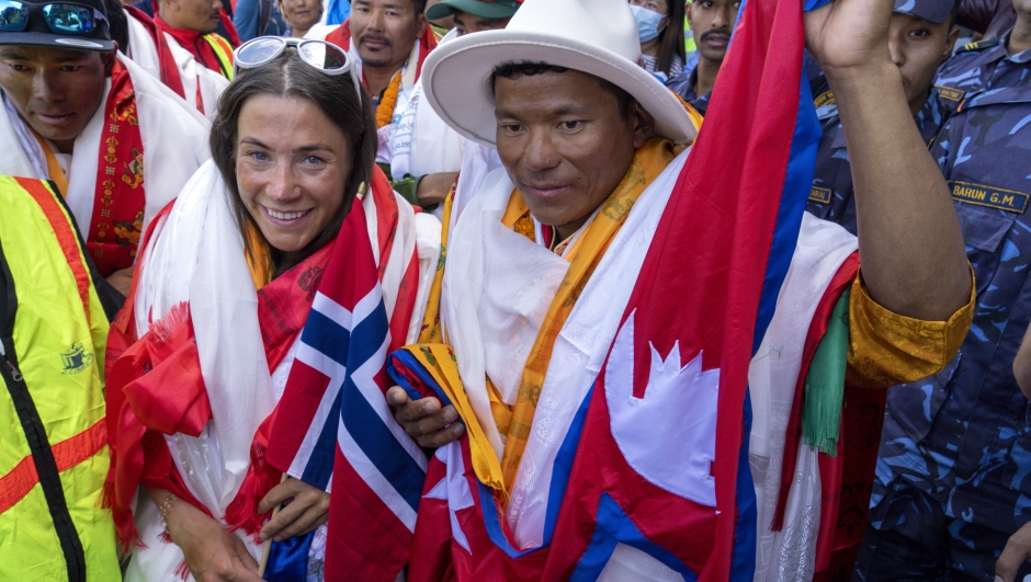 FILE - Norwegian climber Kristin Harila, left, and her Nepali sherpa guide Tenjen Sherpa, right, who climbed the world's 14 tallest mountains in record time, arrive in Kathmandu, Nepal, Saturday, Aug. 5, 2023. A Pakistani mountaineer said Saturday, Aug. 12, 2023, that an investigation has been launched into the death of a Pakistani porter during Harila's record quest. (AP Photo/Niranjan Shrestha, File)