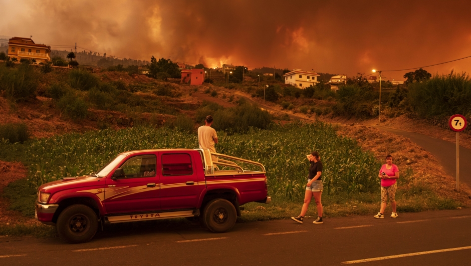 Local residents try to reach their houses in Benijos village as fire advances in La Orotava in Tenerife, Canary Islands, Spain on Saturday, Aug. 19, 2023. Firefighters have battled through the night to try to bring under control the worst wildfire in decades on the Spanish Canary Island of Tenerife, a major tourist destination. The fire in the north of the island started Tuesday night and has forced the evacuation or confinement of nearly 8,000 people. (AP Photo/Arturo Rodriguez)