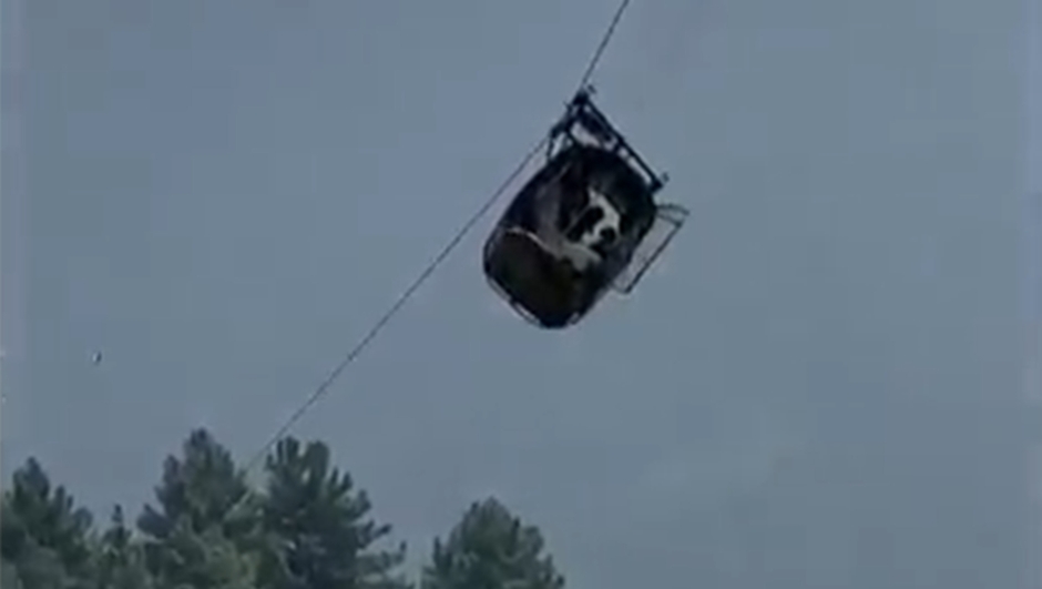In this image taken from video, a cable car carrying six children and two adults dangles hundreds of meters above the ground in the remote Battagram district, Khyber Pakhtunkhwa, Pakistan on Tuesday, Aug. 22, 2023. The cable car malfunctioned, trapping the occupants for hours before rescuers arrived in helicopters to try to free them. (AP Photo)