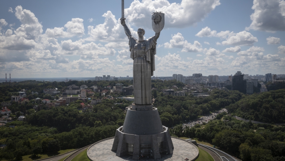 Workers remove the Soviet coat of arms from the shield in the hand of the country's tallest stature, the Motherland Monument, in Kyiv, Ukraine, Tuesday, Aug. 1, 2023. Ukraine is accelerating efforts to erase the vestiges of centuries of Soviet and Russian influence from the public space amid the Russian invasion of Ukraine by pulling down monuments and renaming hundreds of streets to honour home-grown artists, poets, military chiefs, and independence leaders. (AP Photo/Efrem Lukatsky)