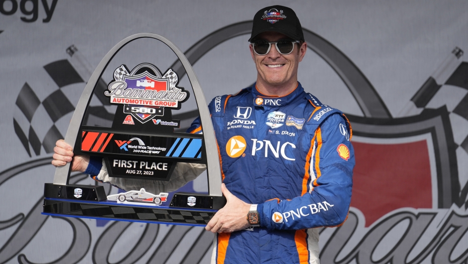 Scott Dixon holds the first place trophy following an IndyCar auto race at World Wide Technology Raceway, Sunday, Aug. 27, 2023, in Madison, Ill. (AP Photo/Jeff Roberson)