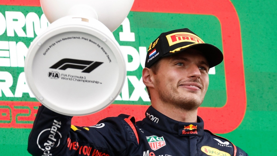 TOPSHOT - Red Bull Racing's Dutch driver Max Verstappen celebrates with the trophy on the podium after winning the Dutch Formula One Grand Prix race at The Circuit Zandvoort, in Zandvoort on August 27, 2023. (Photo by SIMON WOHLFAHRT / AFP)
