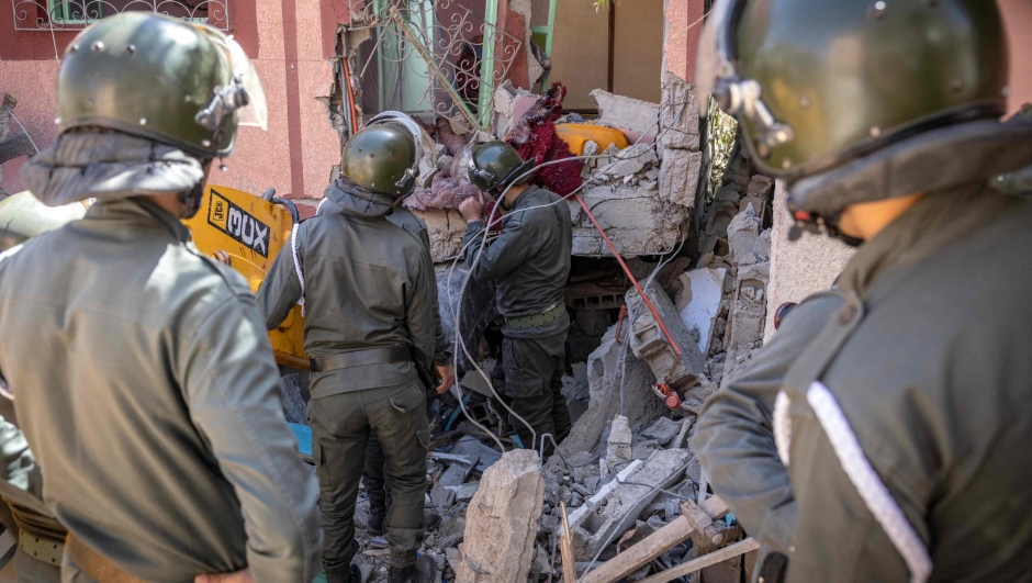Rescuers use a small excavator to search for survivors under the rubble of a collapsed house in Moulay Brahim, Al Haouz province, on September 9, 2023, after an earthquake. Morocco's deadliest earthquake in decades has killed at least 820 people, officials said on September 9, causing widespread damage and sending terrified residents and tourists scrambling to safety in the middle of the night. (Photo by FADEL SENNA / AFP)