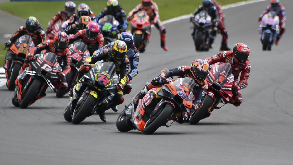 Australian rider Jack Miller of the Red Bull KTM Factory Racing leads the pack at the start of the MotoGP race of the British Motorcycle Grand Prix at the Silverstone racetrack, in Silverstone, England, Sunday, Aug. 6, 2023. (AP Photo/Rui Vieira)