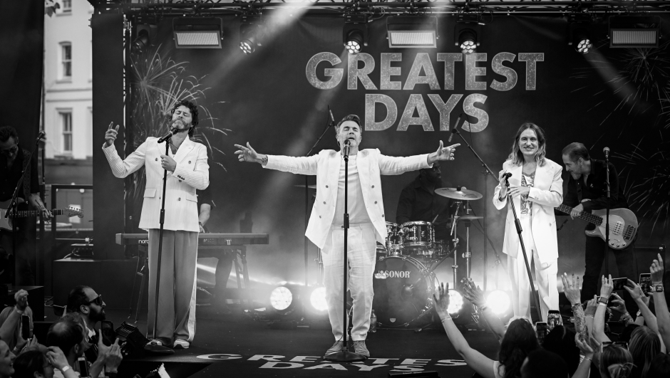 LONDON, ENGLAND - JUNE 15: (EDITORS NOTE: Image has been converted to black and white) Take That (L-R) Howard Donald, Gary Barlow and Mark Owen perform on stage during Take That's "Greatest Days" World Premiere at the Odeon Luxe Leicester Square on June 15, 2023 in London, England. (Photo by Gareth Cattermole/Getty Images)
