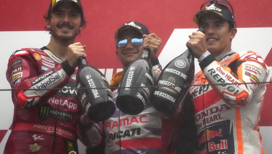 MotoGP race winner Spain's Jorge Martin, center, second placed Italy's Francesco Bagnaia, left, and third placed Spanish rider Marc Marquez pose for a photo on the podium at the Japanese Motorcycle Grand Prix at the Twin Ring Motegi circuit in Motegi, north of Tokyo Sunday, Oct. 1, 2023.(AP Photo/Shuji Kajiyama)