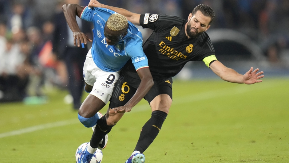 Real Madrid's Nacho, right, challenges Napoli's Victor Osimhen during the Champions League group C soccer match between Napoli and Real Madrid at the Diego Armando Maradona stadium in Naples, Italy, Tuesday, Oct. 3, 2023. (AP Photo/Alessandra Tarantino)