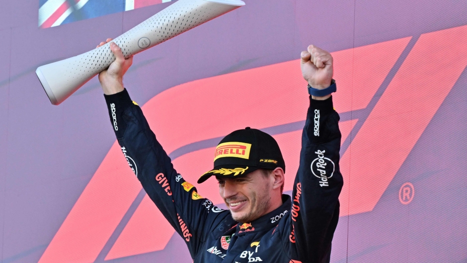 TOPSHOT - Winner Red Bull Racing's Dutch driver Max Verstappen celebrates on the podium at the end of the Formula One Japanese Grand Prix at the Suzuka circuit, Mie prefecture on September 24, 2023. (Photo by Kazuhiro NOGI / AFP)