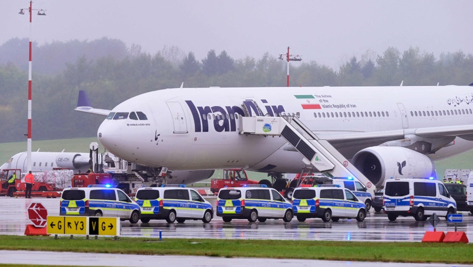 Police search an Airbus A330-200 passenger jet of IranAir at Hamburg airport in norther Germany on October 9, 2023 after reciving a threat. Germany's Hamburg airport said it had resumed service about 90 minutes after halting traffic following a threat against an Iranian flight on October 9, 2023. (Photo by Jonas Walzberg / dpa / AFP) / Germany OUT