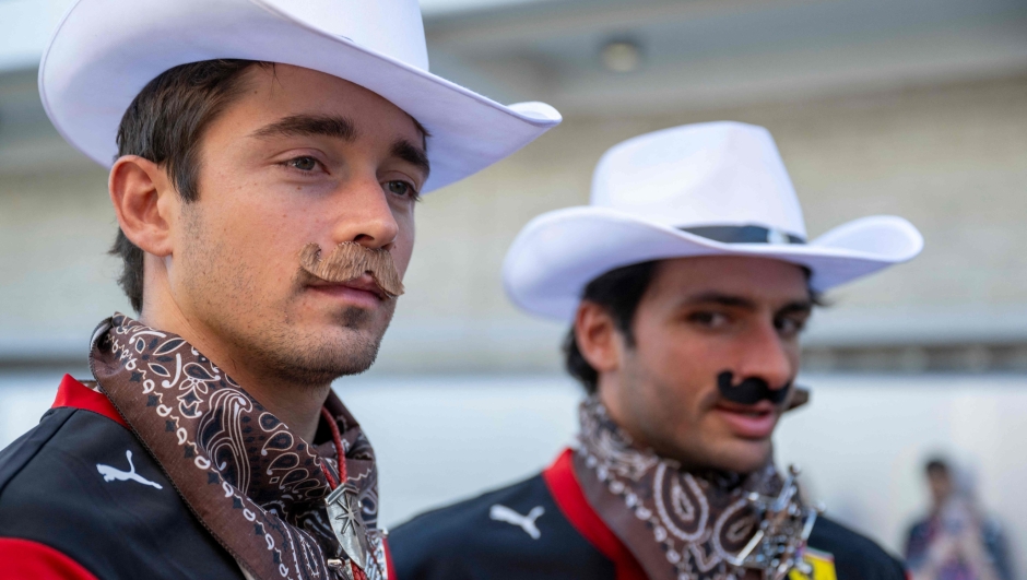 Ferrari's Monegasque driver Charles Leclerc (L) and Ferrari's Spanish driver Carlos Sainz Jr. are dressed as cowboys in the paddock ahead of the United States Formula One Grand Prix at the Circuit of the Americas in Austin, Texas, on October 19, 2023. (Photo by Jim WATSON / AFP)