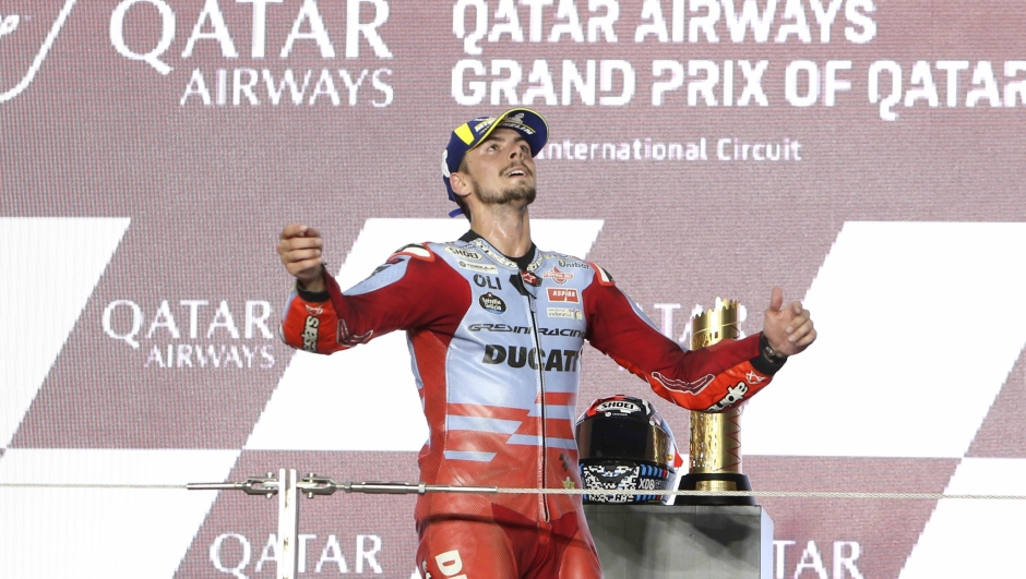 Ducati rider Fabio Di Giannantonio, of Italy, celebrate on the podium after winning the Qatari MotoGP Grand Prix at the Lusail International Circuit in Lusail, Qatar, Sunday, Nov. 19, 2023. (AP Photo/Hussein Sayed)   Associated Press/LaPresse Only Italy and Spain