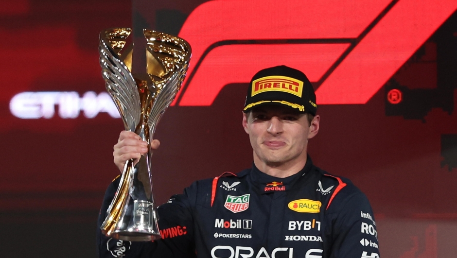 epa10996308 Dutch Formula One driver Max Verstappen of Red Bull Racing celebrates on the podium with his trophy after winning the Formula 1 Abu Dhabi Grand Prix in Abu Dhabi, United Arab Emirates, 26 November 2023.  EPA/ALI HAIDER