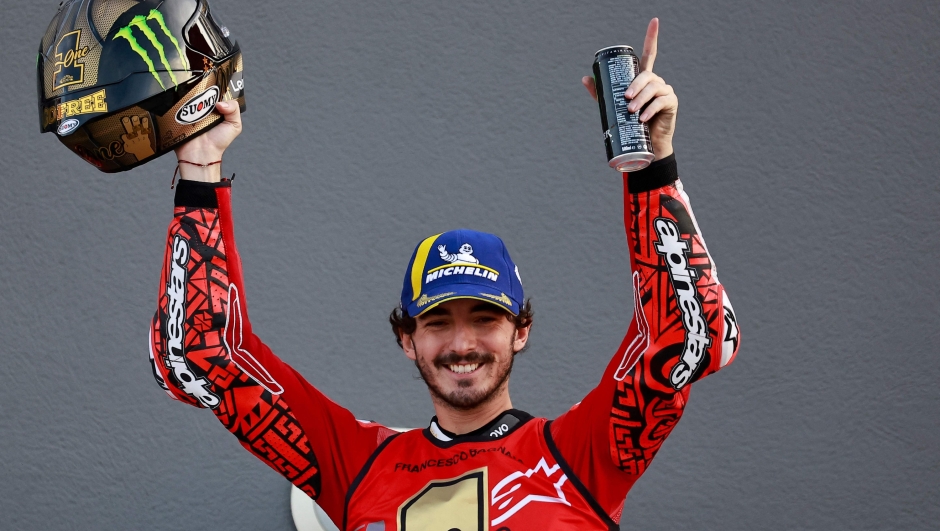 TOPSHOT - Ducati Italian rider Francesco Bagnaia celebrates winning the MotoGP Valencia Grand Prix at the Ricardo Tormo racetrack in Cheste, on November 26, 2023. Italy's Francesco Bagnaia enjoyed a dream day as he retained his MotoGP world title and crowned it with victory in the final race of the season in Valencia today. The 26-year-old Ducati rider had been assured of the championship when his sole rival Jorge Martin crashed early in the race. (Photo by JOSE JORDAN / AFP)