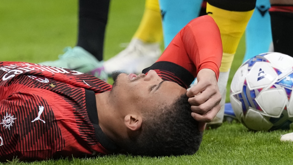 AC Milan's Malick Thiaw glies on the ground after getting injured during the Champions League group F soccer match between AC Milan and Borussia Dortmund at the San Siro stadium in Milan, Italy, Tuesday, Nov. 28, 2023. (AP Photo/Antonio Calanni)