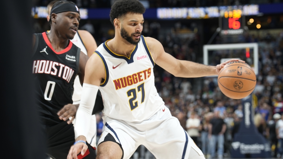 Denver Nuggets guard Jamal Murray, right, drives to the rim as Houston Rockets guard Aaron Holiday defends in the first half of an NBA basketball game on Wednesday, Nov. 29, 2023, in Denver. (AP Photo/David Zalubowski)