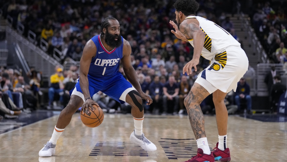 Los Angeles Clippers guard James Harden (1) drives on Indiana Pacers forward Obi Toppin (1) during the second half of an NBA basketball game in Indianapolis, Monday, Dec. 18, 2023. (AP Photo/Michael Conroy)