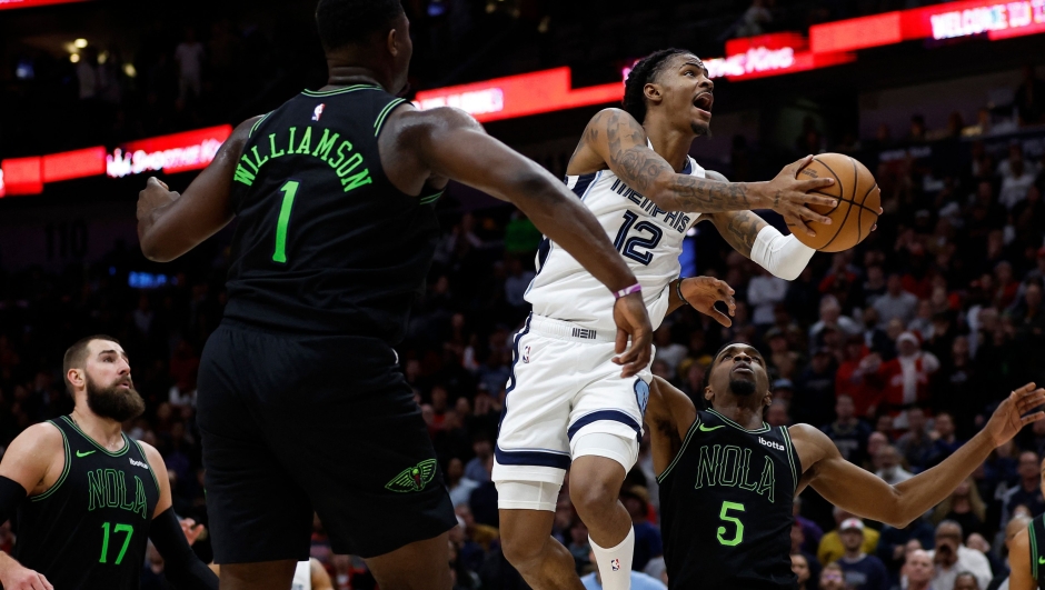 NEW ORLEANS, LOUISIANA - DECEMBER 19: Ja Morant #12 of the Memphis Grizzlies shoots the ball over Zion Williamson #1 of the New Orleans Pelicans at Smoothie King Center on December 19, 2023 in New Orleans, Louisiana. NOTE TO USER: User expressly acknowledges and agrees that, by downloading and or using this photograph, User is consenting to the terms and conditions of the Getty Images License Agreement.   Chris Graythen/Getty Images/AFP (Photo by Chris Graythen / GETTY IMAGES NORTH AMERICA / Getty Images via AFP)