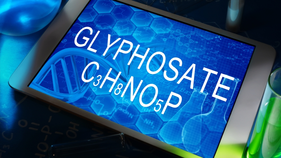 the chemical formula of glyphosate on a tablet with test tubes