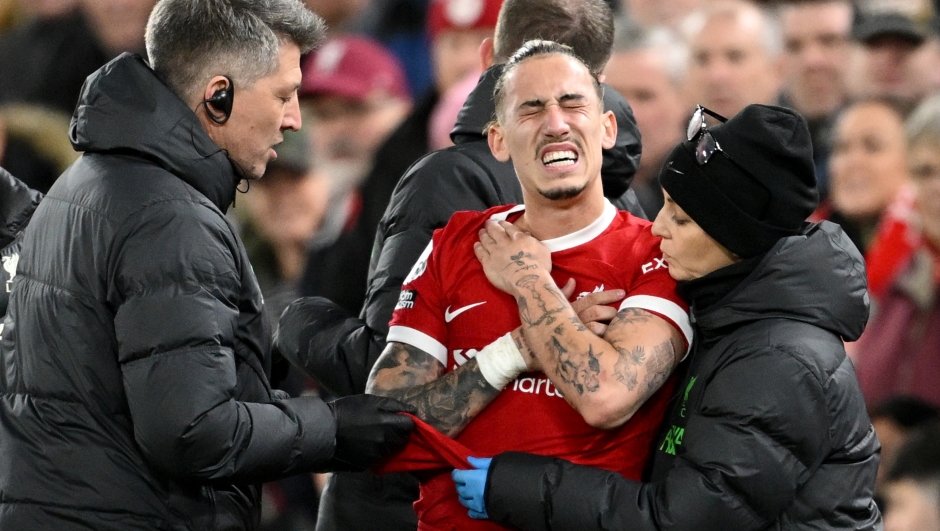 LIVERPOOL, ENGLAND - DECEMBER 23: Kostas Tsimikas of Liverpool receives medical treatment during the Premier League match between Liverpool FC and Arsenal FC at Anfield on December 23, 2023 in Liverpool, England. (Photo by Michael Regan/Getty Images)