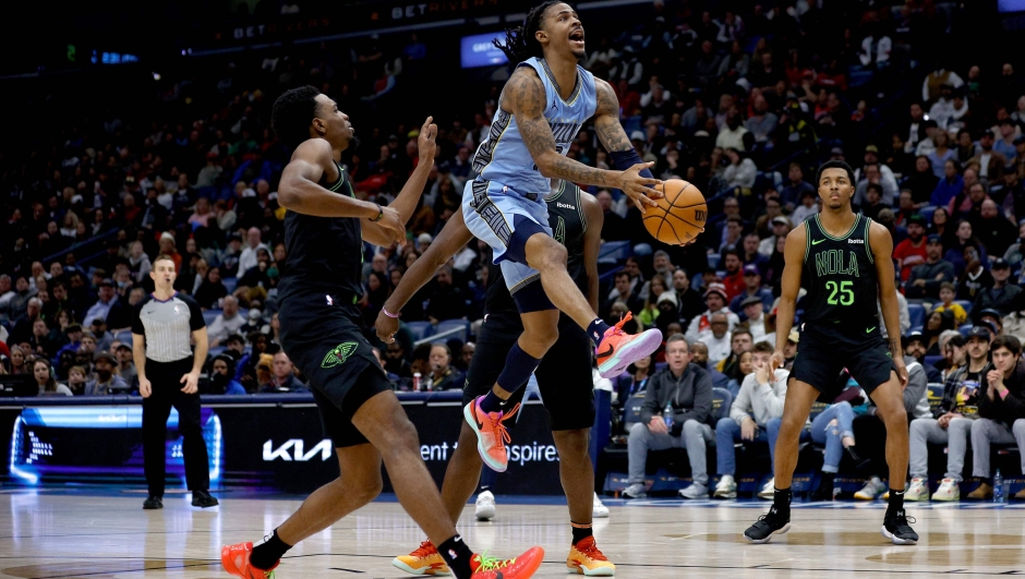 NEW ORLEANS, LOUISIANA - DECEMBER 26: Ja Morant #12 of the Memphis Grizzlies shoots over Herbert Jones #5 of the New Orleans Pelicans during fourth quarter of an NBA game at Smoothie King Center on December 26, 2023 in New Orleans, Louisiana. The Memphis Grizzlies won the game 116 - 115 over the New Orleans Pelicans. NOTE TO USER: User expressly acknowledges and agrees that, by downloading and or using this photograph, User is consenting to the terms and conditions of the Getty Images License Agreement.   Sean Gardner/Getty Images/AFP (Photo by Sean Gardner / GETTY IMAGES NORTH AMERICA / Getty Images via AFP)