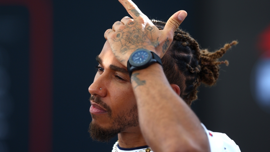 ABU DHABI, UNITED ARAB EMIRATES - NOVEMBER 23: Lewis Hamilton of Great Britain and Mercedes talks to the media in the Paddock during previews ahead of the F1 Grand Prix of Abu Dhabi at Yas Marina Circuit on November 23, 2023 in Abu Dhabi, United Arab Emirates. (Photo by Clive Rose/Getty Images)
