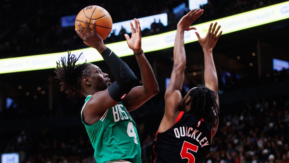 TORONTO, CANADA - JANUARY 15: Jrue Holiday #4 of the Boston Celtics puts up a shot over Immanuel Quickley #5 of the Toronto Raptors during the first half of their NBA game at Scotiabank Arena on January 15, 2024 in Toronto, Canada. NOTE TO USER: User expressly acknowledges and agrees that, by downloading and or using this photograph, User is consenting to the terms and conditions of the Getty Images License Agreement.   Cole Burston/Getty Images/AFP (Photo by Cole Burston / GETTY IMAGES NORTH AMERICA / Getty Images via AFP)