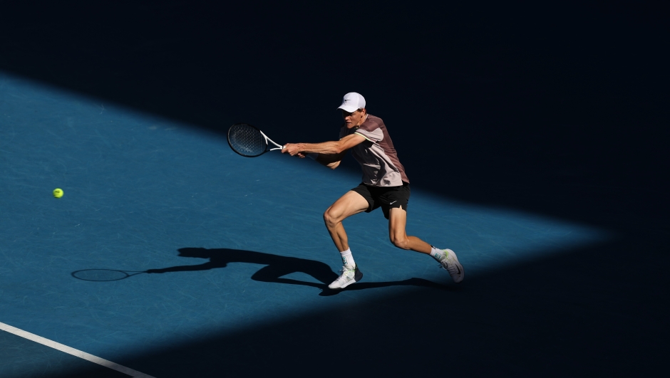 MELBOURNE, AUSTRALIA - JANUARY 26: Jannik Sinner of Italy plays a forehand in their Semifinal singles match against Novak Djokovic of Serbia during the 2024 Australian Open at Melbourne Park on January 26, 2024 in Melbourne, Australia. (Photo by Cameron Spencer/Getty Images)
