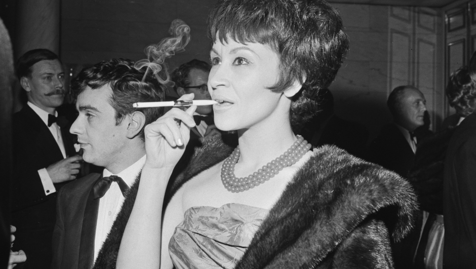 FILE - JANUARY 30: Actress, singer, and dancer Chita Rivera, known most for starring in Broadway's "West Side Story" and "Chicago," has died. She was 91 years old. American actress and singer Chita Rivera, smoking a cigarette in a cigarette holder, attends the Evening Standard Drama Awards for 1961, held at the Savoy Hotel in London, England, 23rd January 1962. (Photo by Evening Standard/Hulton Archive/Getty Images)