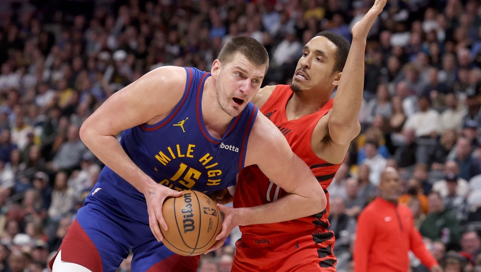 DENVER, COLORADO - FEBRUARY 02: Nikola Jokic #15 of the Denver Nuggets drives against Malcolm Brogdon #11 of the Portland Trail Blazers in the fourth quarter at Ball Arena on February 02, 2024 in Denver, Colorado. NOTE TO USER: User expressly acknowledges and agrees that, by downloading and or using this photograph, User is consenting to the terms and conditions of the Getty Images License Agreement.   Matthew Stockman/Getty Images/AFP (Photo by MATTHEW STOCKMAN / GETTY IMAGES NORTH AMERICA / Getty Images via AFP)