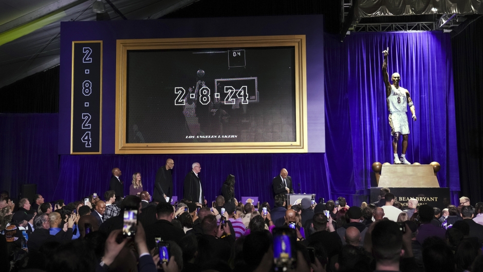 Attendees view a statue of former Los Angeles Lakers guard Kobe Bryant after its unveiling outside the NBA basketball team's arena, Thursday, Feb. 8, 2024, in Los Angeles. (AP Photo/Eric Thayer)