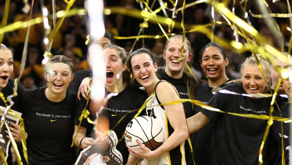 IOWA CITY, IOWA- FEBRUARY 15: Guard Caitlin Clark #22 of the Iowa Hawkeyes celebrates with teammates during a presentation after breaking the NCAA women's all-time scoring record during the game against the Michigan Wolverines at Carver-Hawkeye Arena on February 15, 2024 in Iowa City, Iowa.   Matthew Holst/Getty Images/AFP (Photo by Matthew Holst / GETTY IMAGES NORTH AMERICA / Getty Images via AFP)
