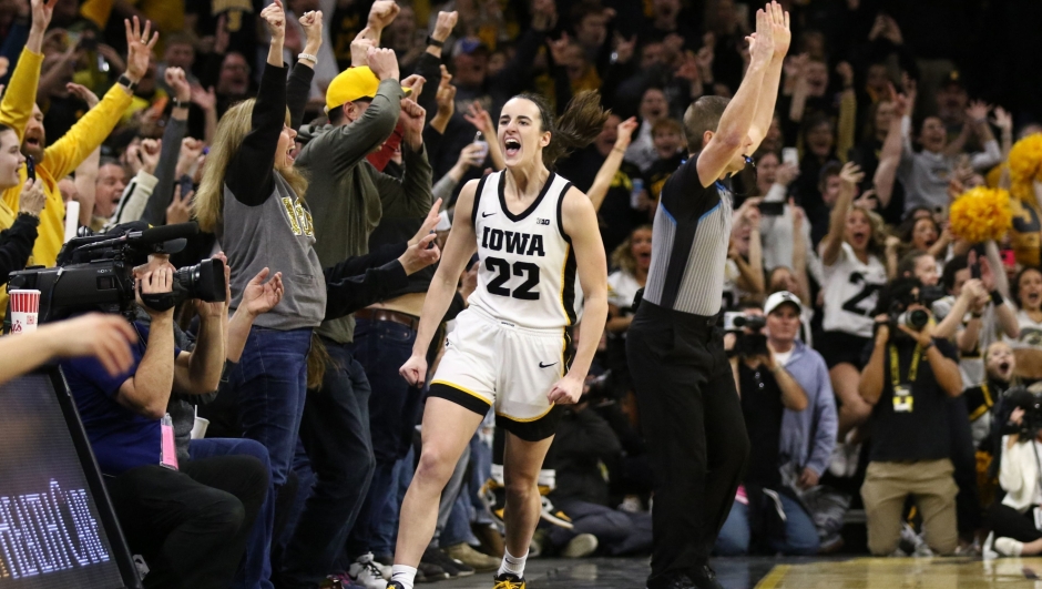 IOWA CITY, IOWA- FEBRUARY 15: Guard Caitlin Clark #22 of the Iowa Hawkeyes celebrates after breaking the NCAA women's all-time scoring record during the first half against the Michigan Wolverines at Carver-Hawkeye Arena on February 15, 2024 in Iowa City, Iowa.   Matthew Holst/Getty Images/AFP (Photo by Matthew Holst / GETTY IMAGES NORTH AMERICA / Getty Images via AFP)