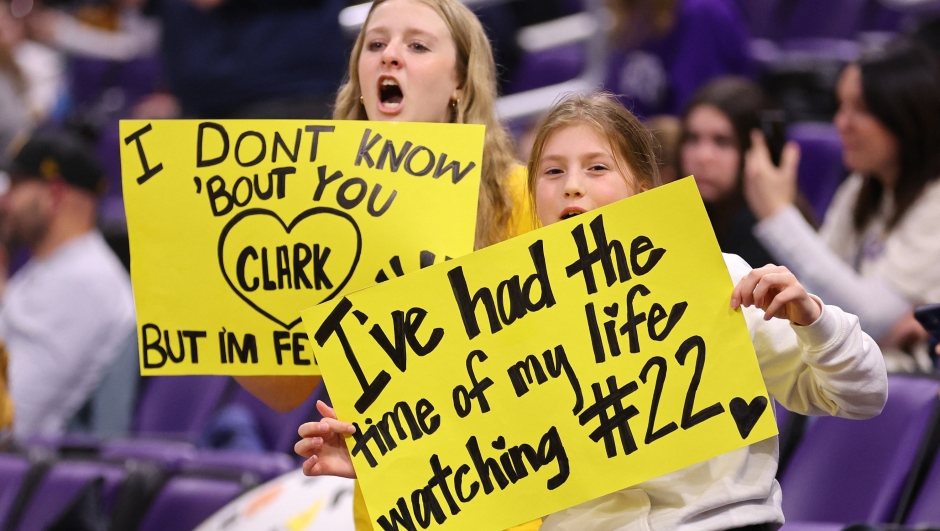 EVANSTON, ILLINOIS - JANUARY 31: Young Iowa Hawkeyes fans hold signs for Caitlin Clark #22 of the Iowa Hawkeyes (not pictured) as she warms up prior to the game against the Northwestern Wildcats at Welsh-Ryan Arena on January 31, 2024 in Evanston, Illinois.   Michael Reaves/Getty Images/AFP (Photo by Michael Reaves / GETTY IMAGES NORTH AMERICA / Getty Images via AFP)