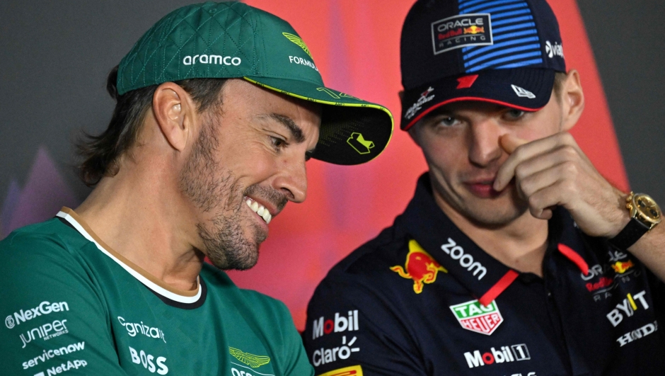 Aston Martin's Spanish driver Fernando Alonso (L) listens to Red Bull Racing's Dutch driver Max Verstappen during a press conference at the Bahrain International Circuit in Sakhir on February 28, 2024, ahead of the Bahrain Formula One Grand Prix. (Photo by ANDREJ ISAKOVIC / AFP)