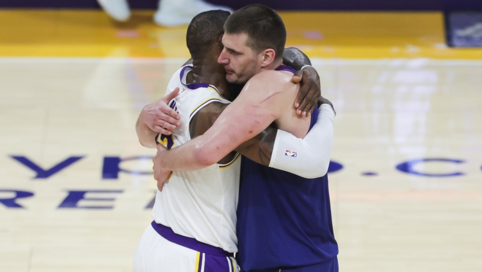 Los Angeles Lakers forward LeBron James, left, and Denver Nuggets center Nikola Jokic (15) embrace after an NBA basketball game Saturday, March 2, 2024, in Los Angeles. (AP Photo/Yannick Peterhans)