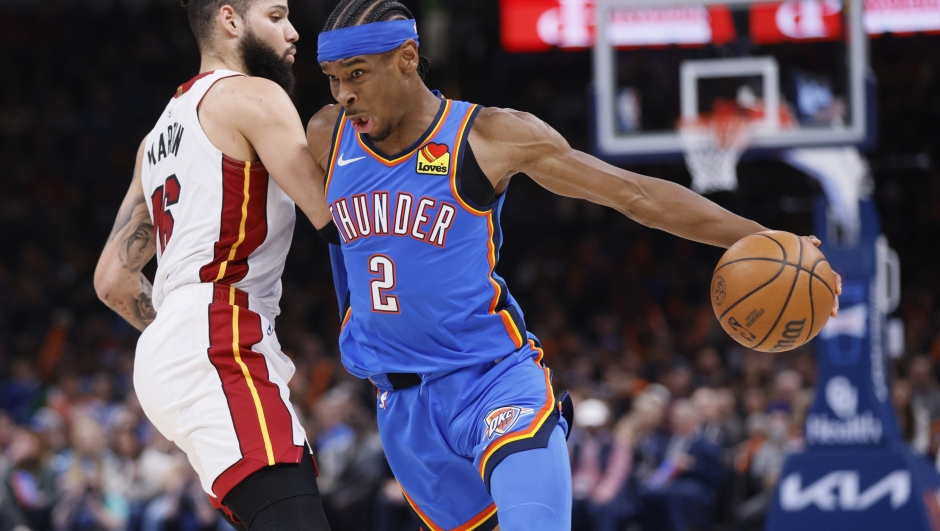 Oklahoma City Thunder guard Shai Gilgeous-Alexander (2) drives against Miami Heat forward Caleb Martin, left, during the second half of an NBA basketball game Friday, March 8, 2024, in Oklahoma City. (AP Photo/Nate Billings)