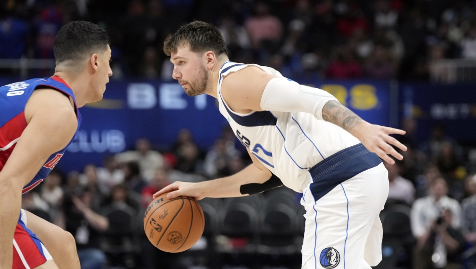 Dallas Mavericks guard Luka Doncic (77) drives on Detroit Pistons forward Simone Fontecchio during the second half of an NBA basketball game, Saturday, March 9, 2024, in Detroit. (AP Photo/Carlos Osorio)