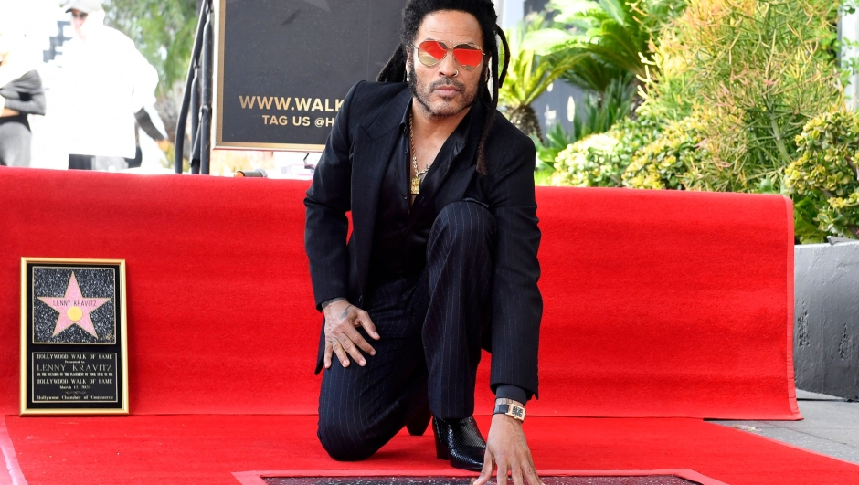 US musician Lenny Kravitz poses on his newly unveiled star during his Walk of Fame ceremony in Los Angeles, California, on March 12, 2024. (Photo by VALERIE MACON / AFP)