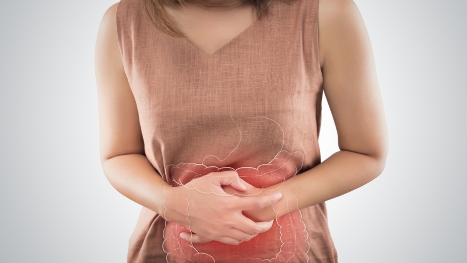 The Photo Of Large Intestine Is On The Woman's Body. People With Stomach Ache Problem Concept. Female Anatomy