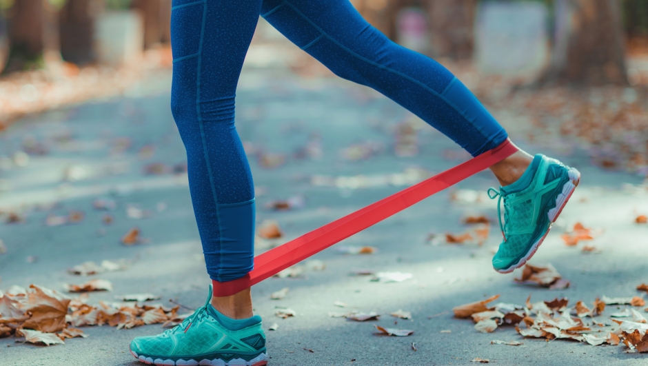 Woman Exercising with Resistance Band in a Park