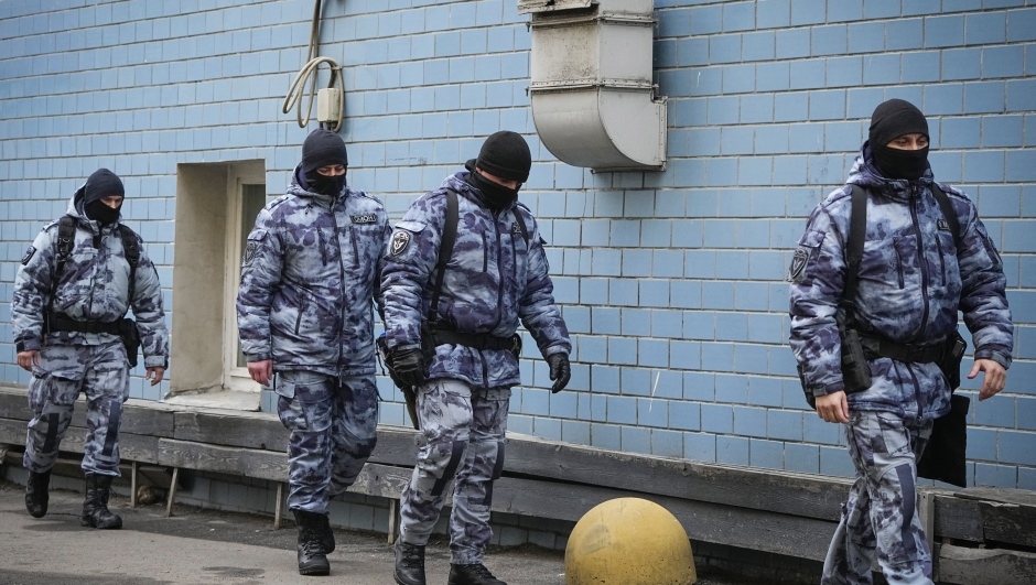 Police officers walk near the Basmanny District Court in Moscow, Russia, Sunday, March 24, 2024. The suburban Moscow concert hall where gunmen opened fire on concertgoers was a blackened, smoldering ruin as the death toll in the attack surpassed 130 and Russian authorities arrested four suspects. (AP Photo/Alexander Zemlianichenko)